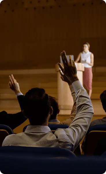 Audience member raising a hand during a TechWhizz event session